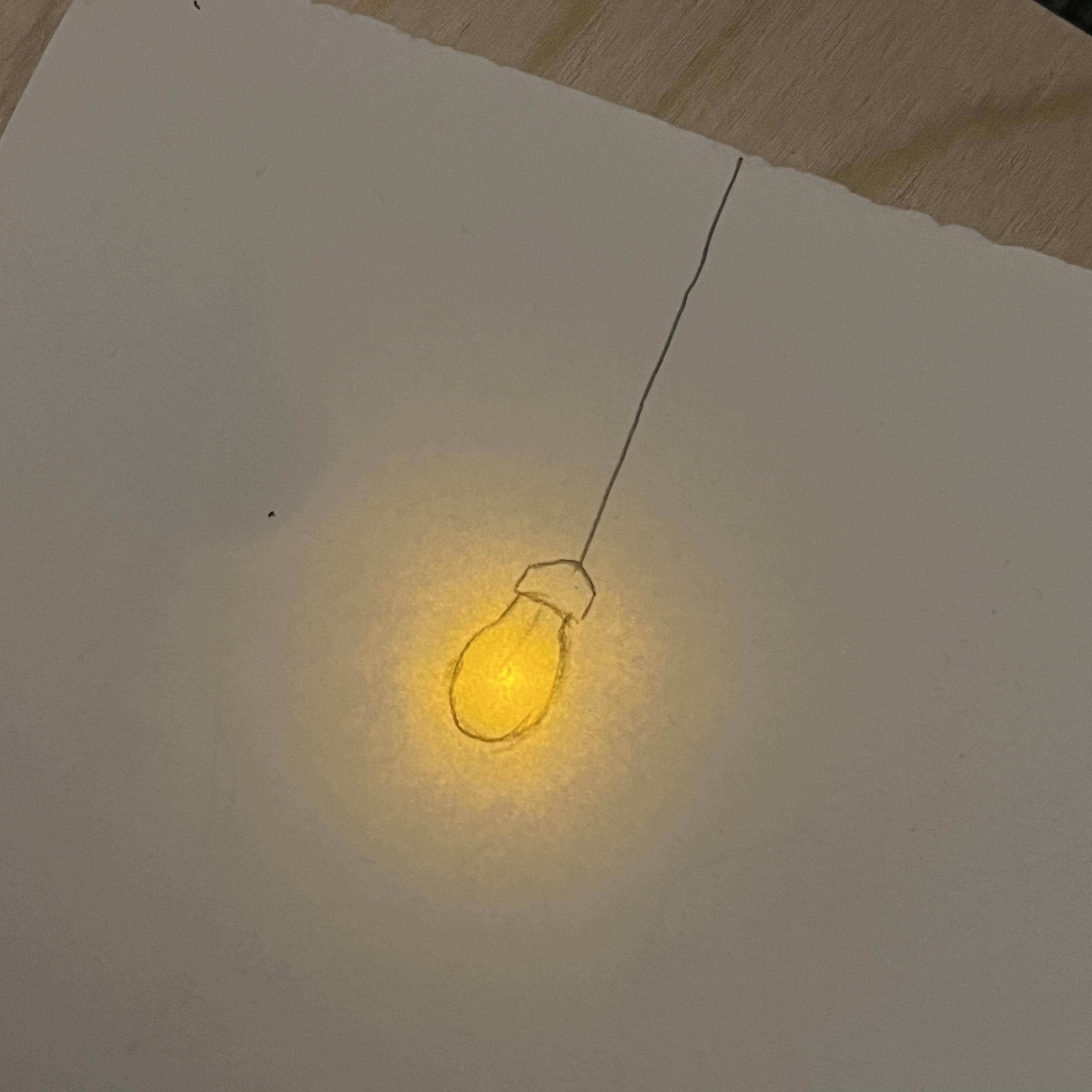 Yellow LED light gives the allusion of a lit up light bulb