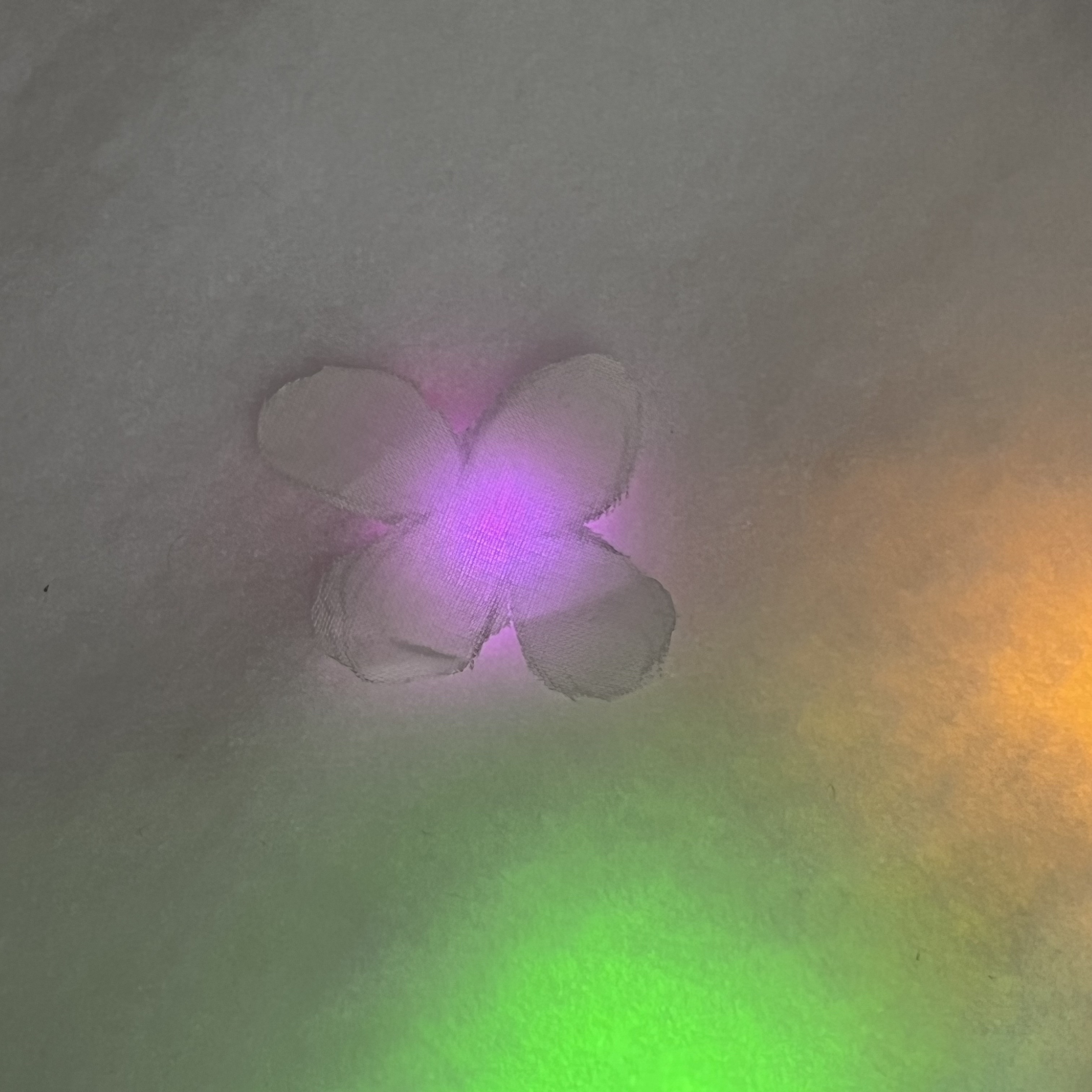 Fabric flowers on top of fabric that gives off a glowing effect to the flowers