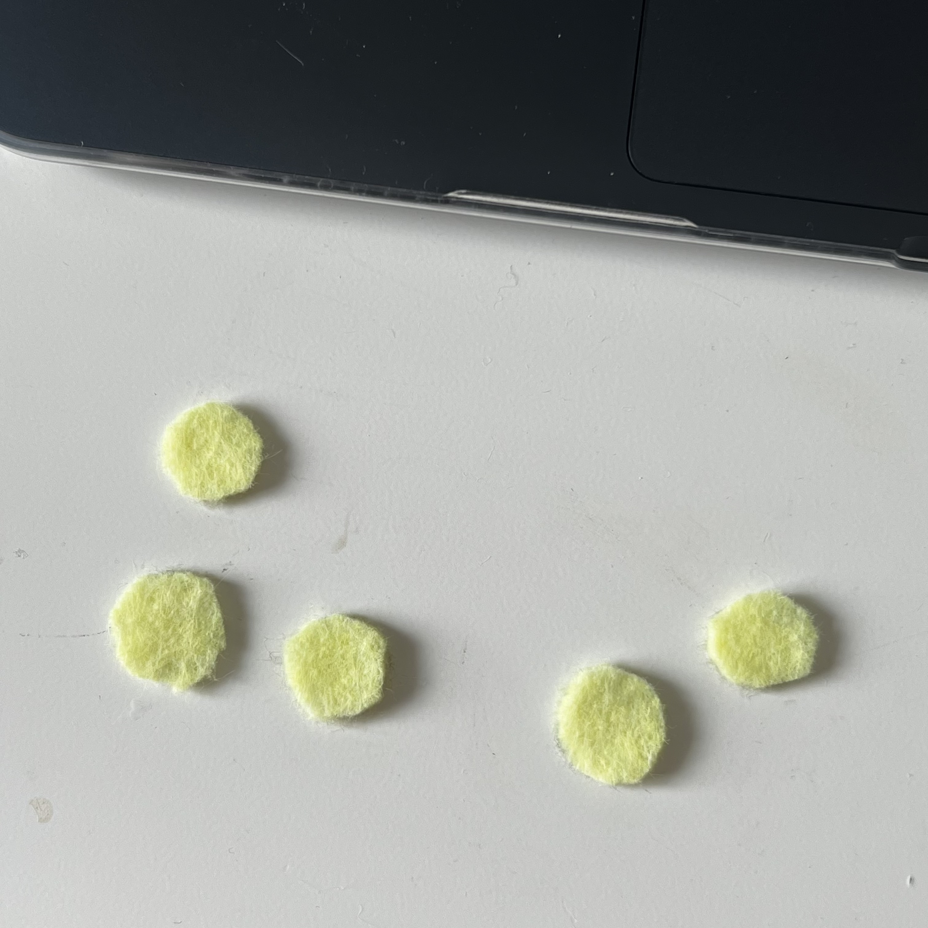 Cutting out felt circles to use as buttons