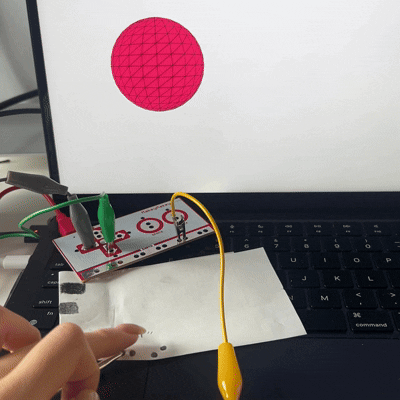 Connecting a Makey Makey clip to the graphite pencil and using it as a arrow key